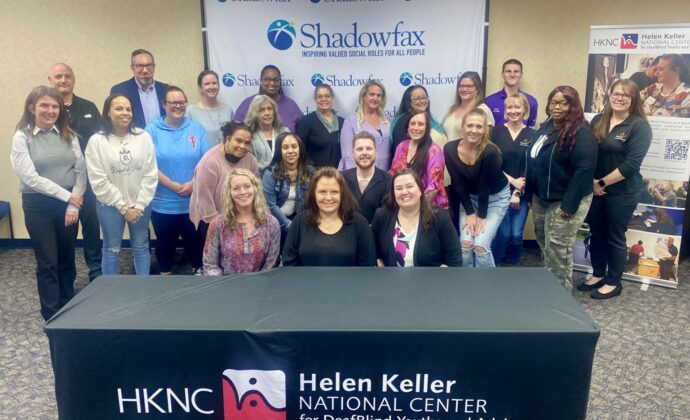 Seated at the HKNC-branded table in the front row center is Tammie Christian (HKNC’s DBIE Coordinator), with Amy Brillinger (CEO of Shadowfax) on her right and Lea Sheffield (Special Populations Unit Manager with ODP) on her left. Standing behind them are Shadowfax staff members along with two representatives from Pennsylvania’s Office of Developmental Programs (ODP).